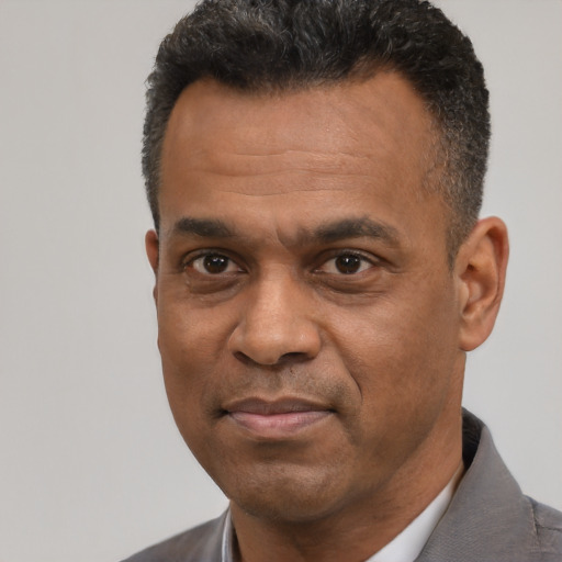 Neutral latino adult male with short  black hair and brown eyes