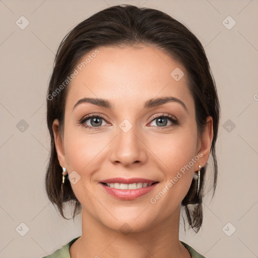 Joyful white young-adult female with medium  brown hair and grey eyes