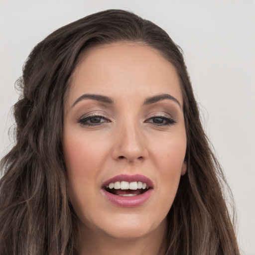 Joyful white young-adult female with long  brown hair and brown eyes