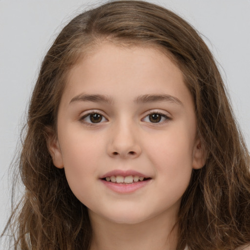 Joyful white child female with long  brown hair and brown eyes