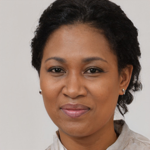 Joyful black adult female with short  black hair and brown eyes