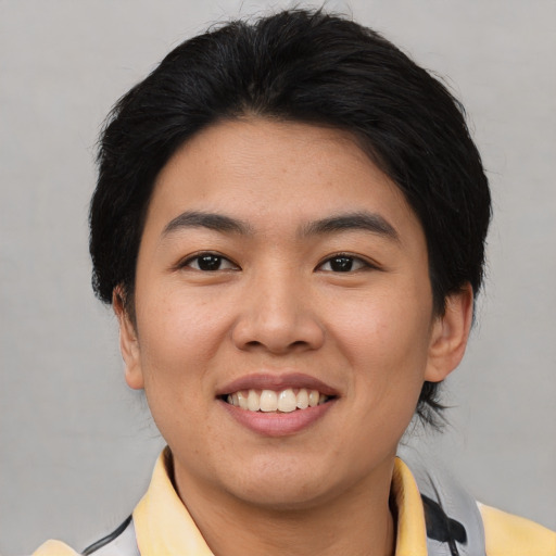 Joyful asian young-adult female with short  brown hair and brown eyes