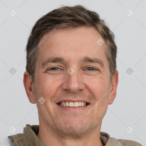 Joyful white adult male with short  brown hair and grey eyes