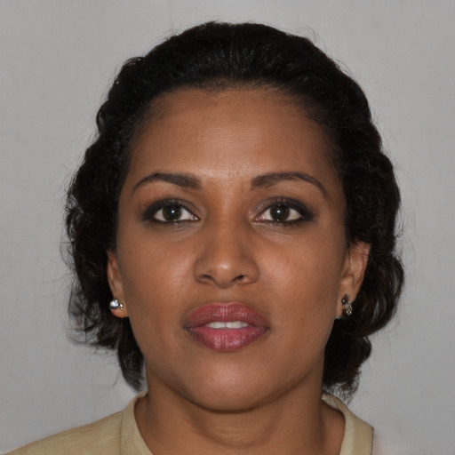 Joyful black young-adult female with medium  brown hair and brown eyes