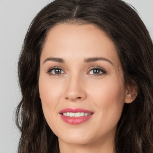 Joyful white young-adult female with long  brown hair and brown eyes