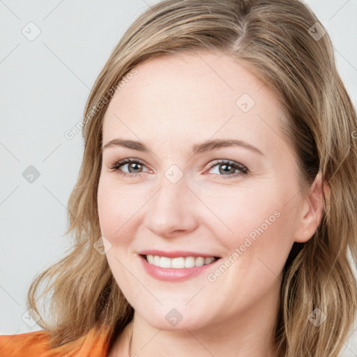 Joyful white young-adult female with medium  brown hair and blue eyes