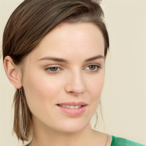 Joyful white young-adult female with medium  brown hair and green eyes