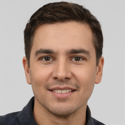 Joyful white young-adult male with short  brown hair and brown eyes