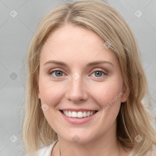 Joyful white young-adult female with medium  brown hair and blue eyes