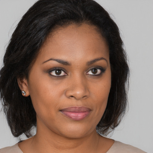 Joyful black young-adult female with medium  brown hair and brown eyes