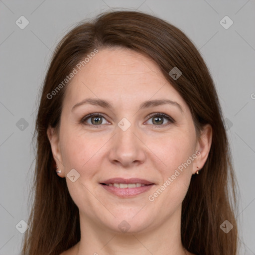 Joyful white adult female with long  brown hair and grey eyes