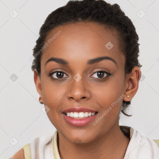 Joyful black young-adult female with short  brown hair and brown eyes