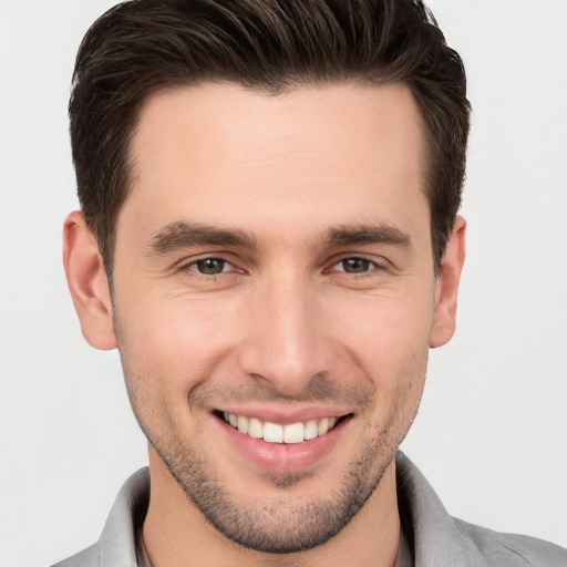 Joyful white young-adult male with short  brown hair and brown eyes