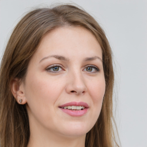 Joyful white young-adult female with long  brown hair and green eyes