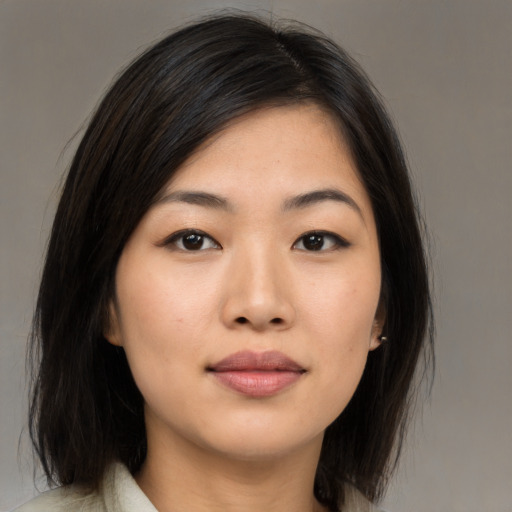 Joyful asian young-adult female with medium  black hair and brown eyes