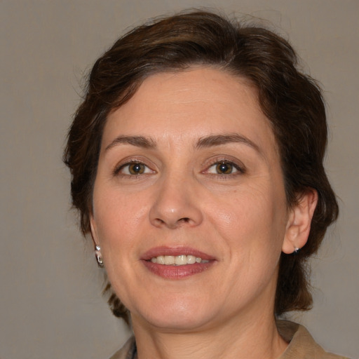 Joyful white adult female with medium  brown hair and brown eyes