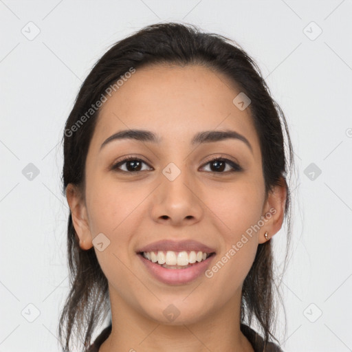 Joyful latino young-adult female with long  brown hair and brown eyes