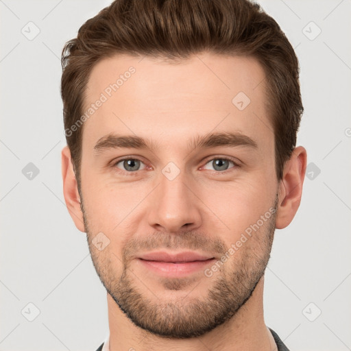 Joyful white young-adult male with short  brown hair and grey eyes