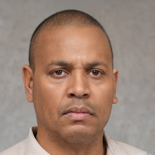 Neutral latino adult male with short  brown hair and brown eyes