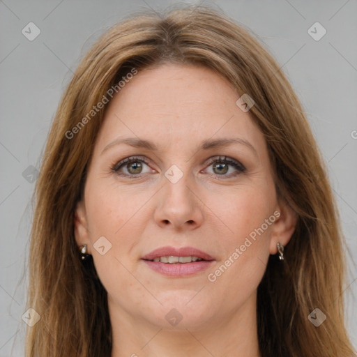 Joyful white adult female with long  brown hair and green eyes