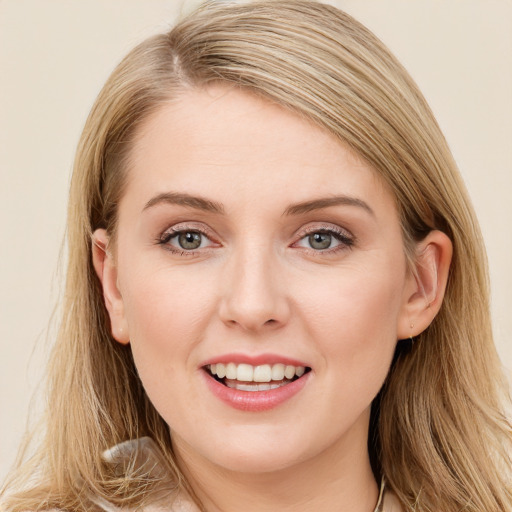 Joyful white young-adult female with long  brown hair and blue eyes