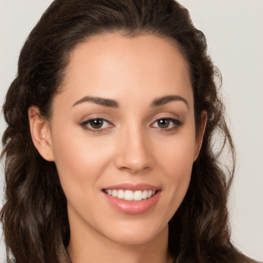 Joyful white young-adult female with long  brown hair and brown eyes