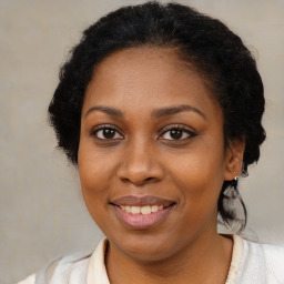 Joyful black young-adult female with medium  brown hair and brown eyes