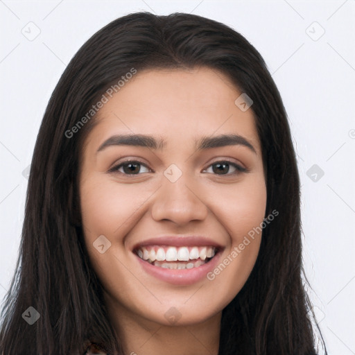 Joyful latino young-adult female with long  black hair and brown eyes