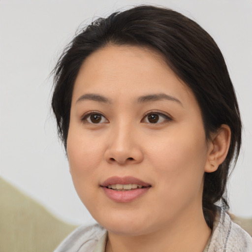 Joyful asian young-adult female with medium  brown hair and brown eyes