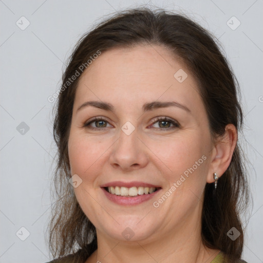 Joyful white adult female with medium  brown hair and grey eyes