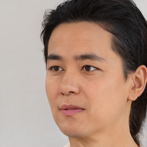 Joyful asian young-adult male with medium  black hair and brown eyes