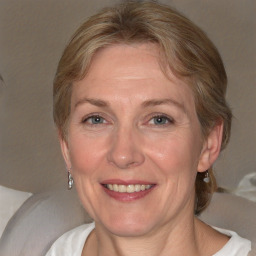 Joyful white adult female with medium  brown hair and blue eyes