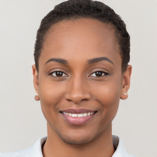 Joyful black young-adult female with short  brown hair and brown eyes