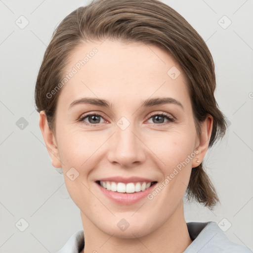 Joyful white young-adult female with short  brown hair and grey eyes