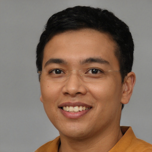 Joyful latino young-adult male with short  brown hair and brown eyes