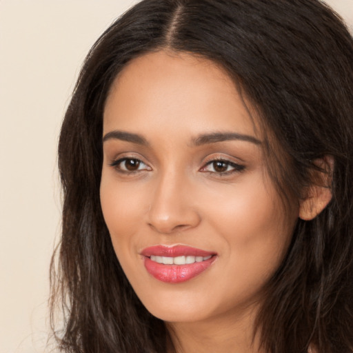 Joyful white young-adult female with long  brown hair and brown eyes