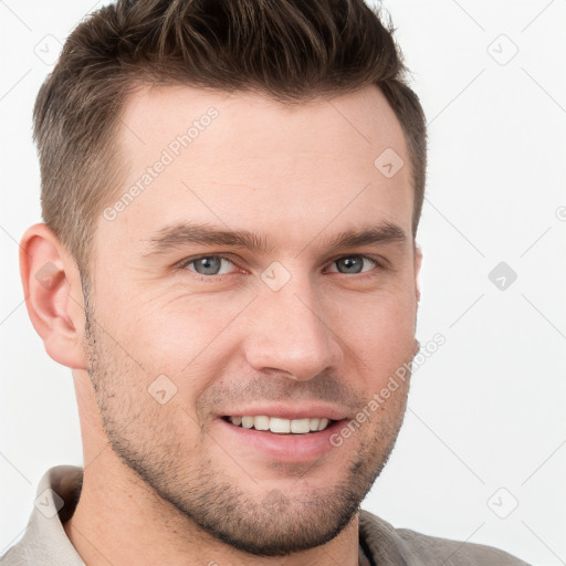 Joyful white young-adult male with short  brown hair and grey eyes