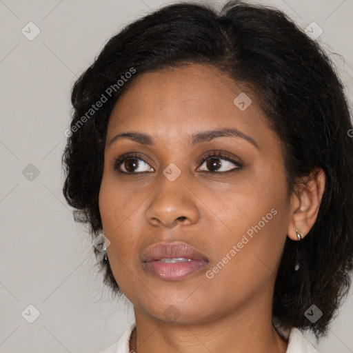 Joyful black young-adult female with medium  brown hair and brown eyes