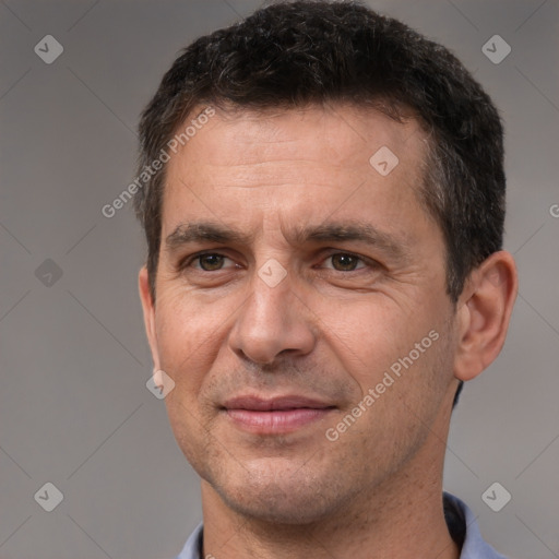 Joyful white adult male with short  brown hair and brown eyes