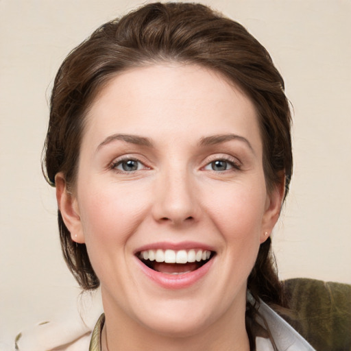 Joyful white young-adult female with medium  brown hair and grey eyes