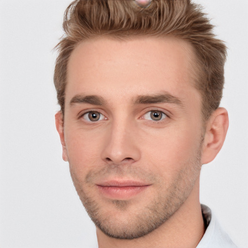 Joyful white young-adult male with short  brown hair and grey eyes