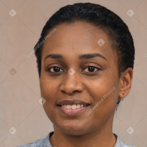 Joyful black young-adult female with short  black hair and brown eyes