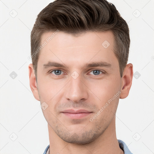 Joyful white young-adult male with short  brown hair and grey eyes