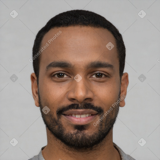 Joyful black young-adult male with short  black hair and brown eyes