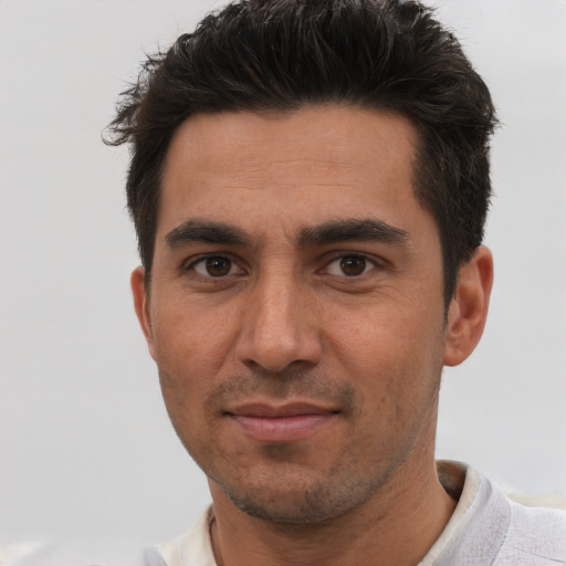Joyful white adult male with short  brown hair and brown eyes