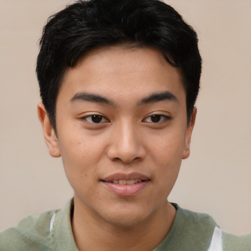 Joyful asian young-adult male with short  brown hair and brown eyes