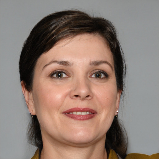 Joyful white adult female with medium  brown hair and brown eyes