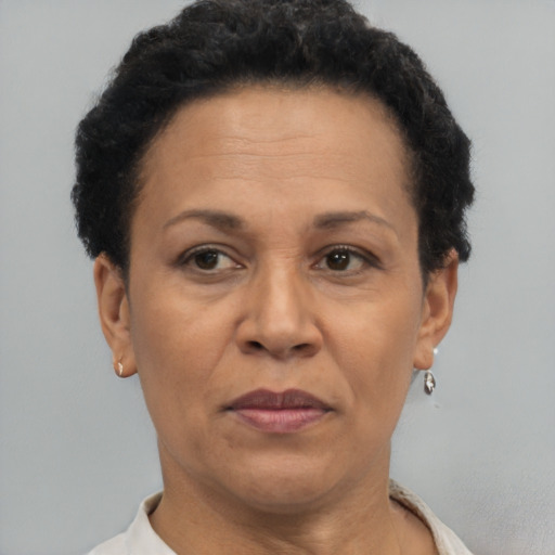 Joyful latino adult female with short  brown hair and brown eyes