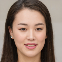 Joyful asian young-adult female with long  brown hair and brown eyes