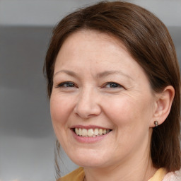 Joyful white adult female with medium  brown hair and brown eyes